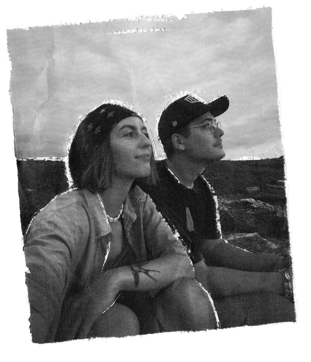 A boy and a girl are watching the sunset